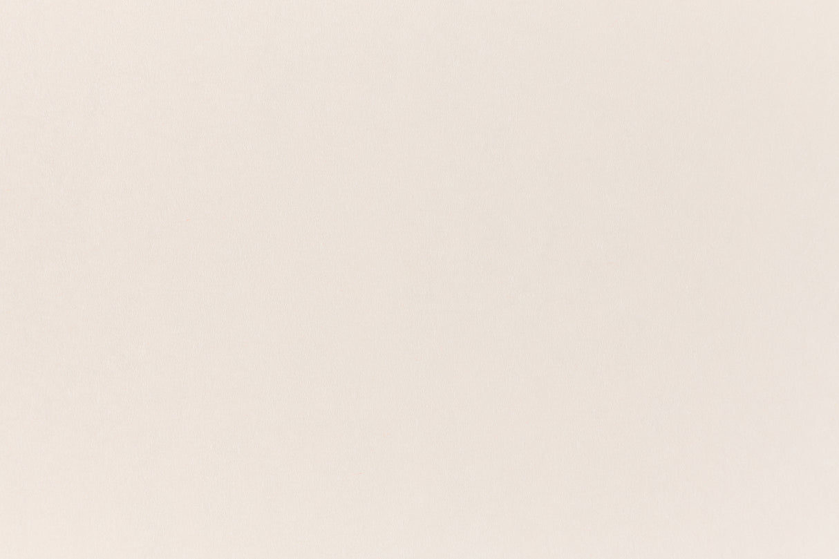A soft, light pink construction-style cardstock paper viewed closeup.