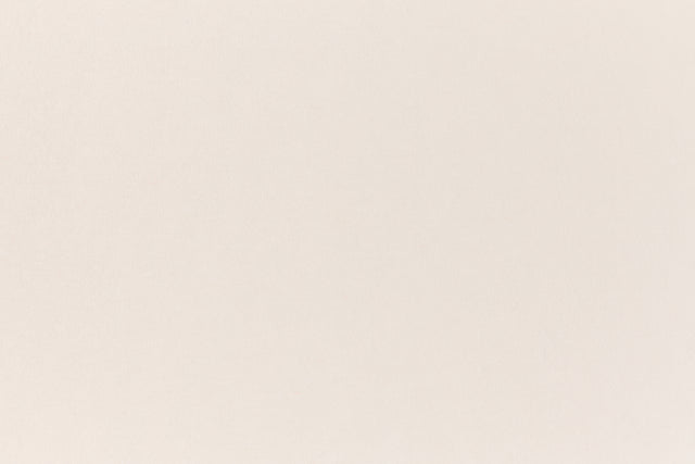 A soft, light pink construction-style cardstock paper viewed closeup.
