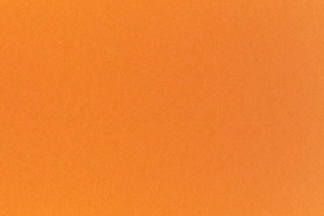 Bright neon orange cardstock paper sample.