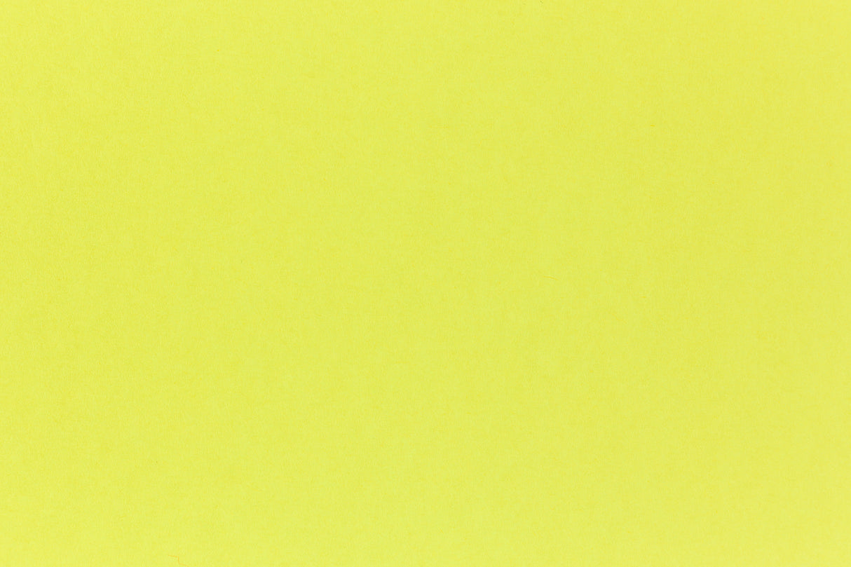 Brilliant neon yellow cardstock paper in close detail.