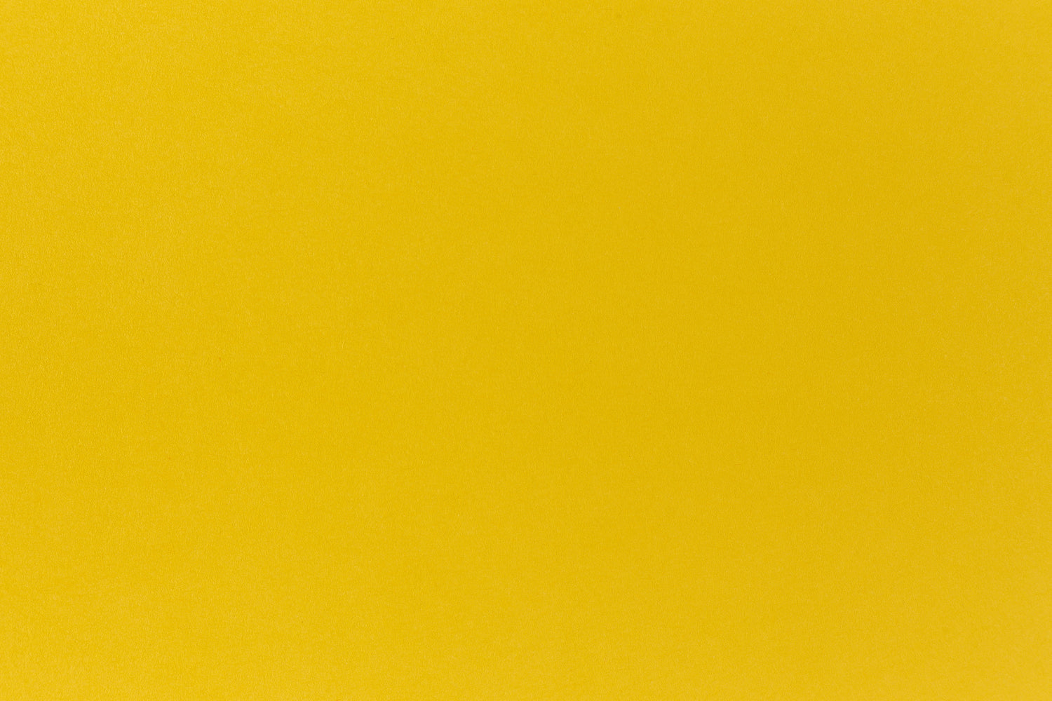 Deep yellow crafting paper shown in close detail.