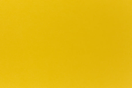 Deep yellow crafting paper shown in close detail.