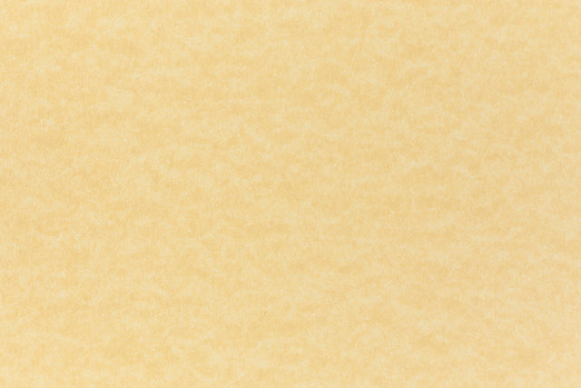 A subdued gold color paper viewed closeup.