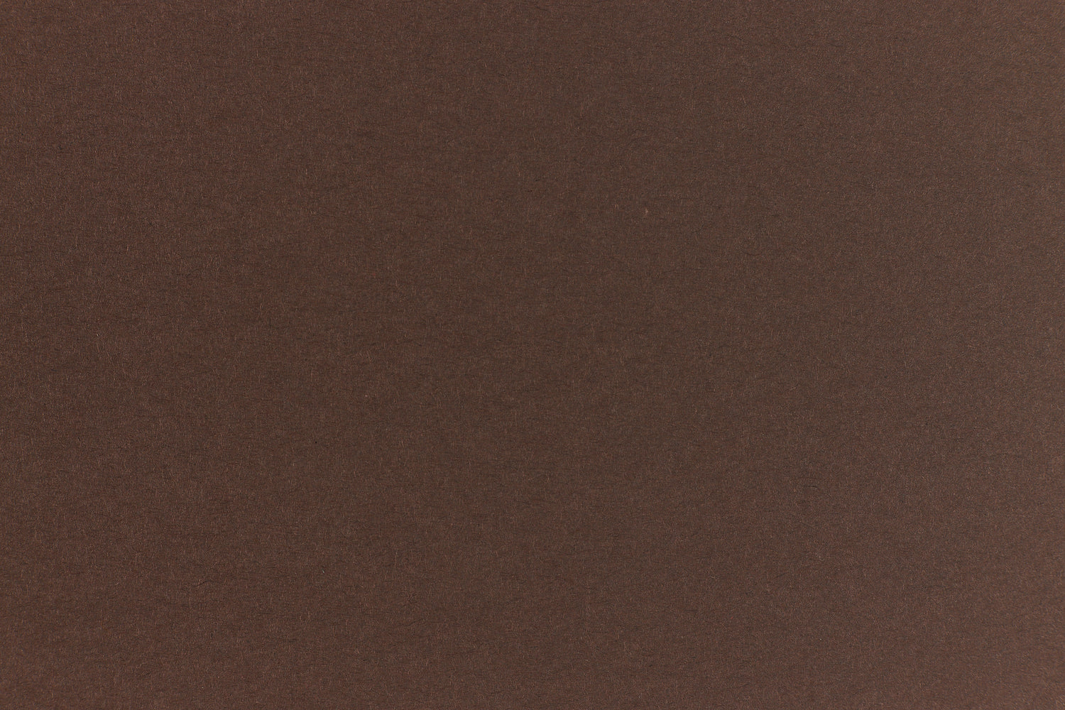 A deep and dark brown-black paper viewed in close detail.