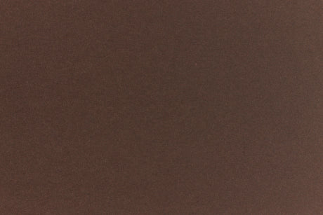 A deep and dark brown-black paper viewed in close detail.
