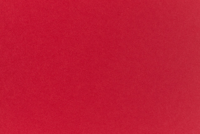Bright red crafting paper viewed close up.