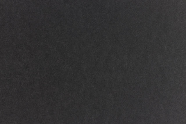 Subtly textured black paper viewed close up.