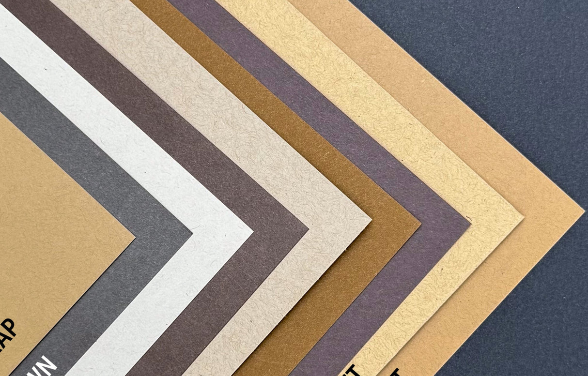 Collection of different colored paper samples arranged in a pattern.