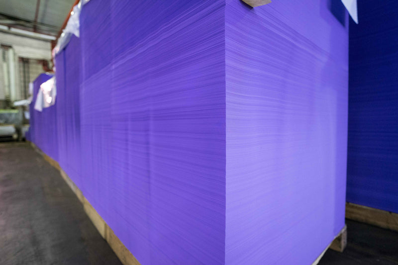 Large sheets of purple material on a pallet in an industrial setting