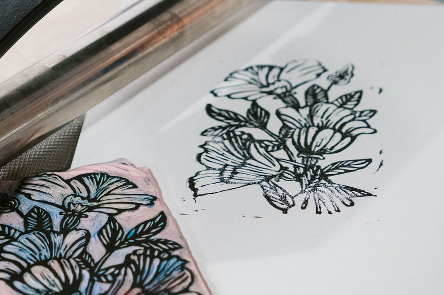 Woodblock printing process with a printed design on paper and block.