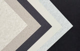 A stack of gray-colored paper sheets in various shades, displaying different textures and weights.