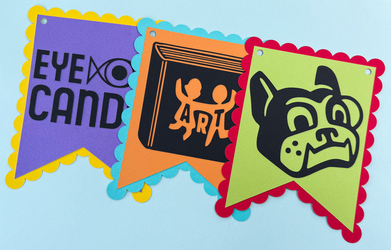 Colorful paper banners with decorative edges on a light blue background