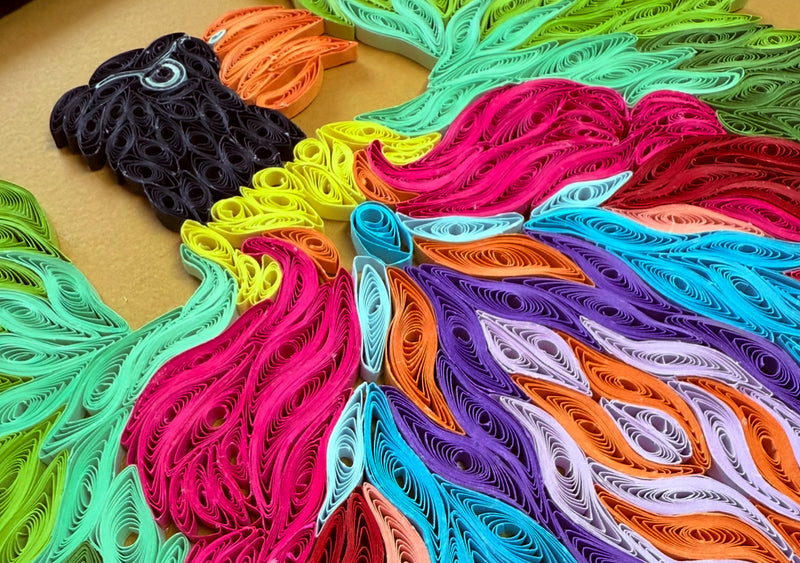 Colorful paper quilling art on a kraft paper surface