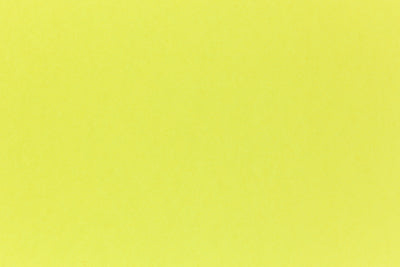 Brilliant neon yellow cardstock paper in close detail. 