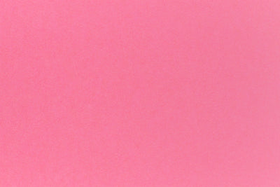 Bright pink crafting paper in close detail.