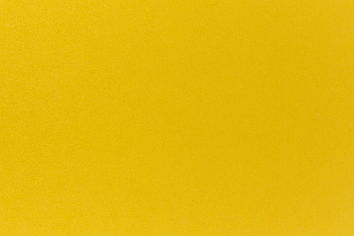 Deep yellow crafting paper shown in close detail. 