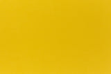 Deep yellow crafting paper shown in close detail. 