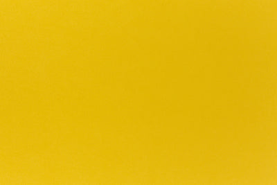 Deep yellow crafting paper shown in close detail. 