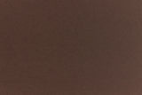 A deep and dark brown-black paper viewed in close detail. 